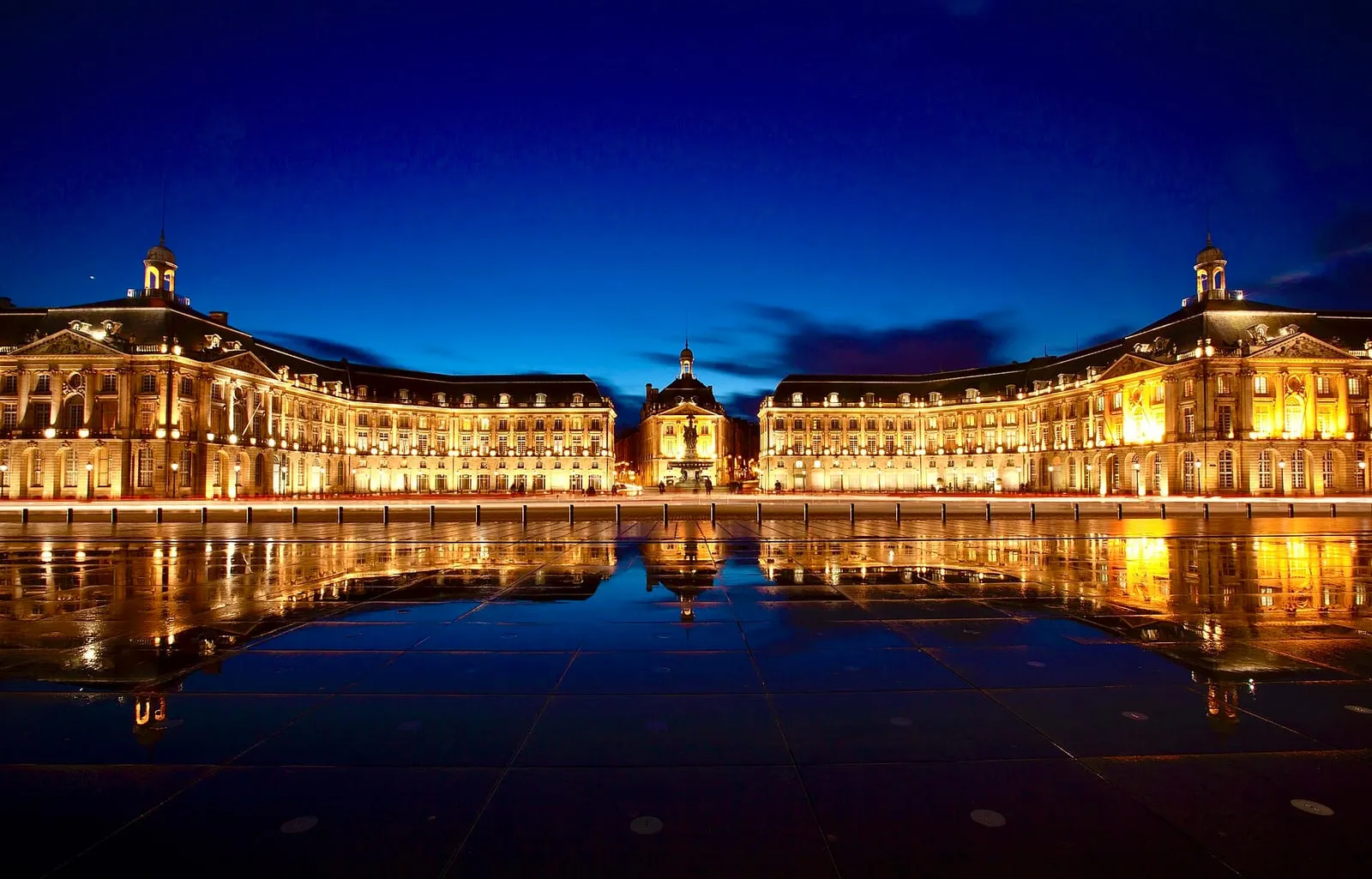 The Place de la Bourse and its mirror-water reflecting pool along the Garonne river in Bordeaux, France, at dusk