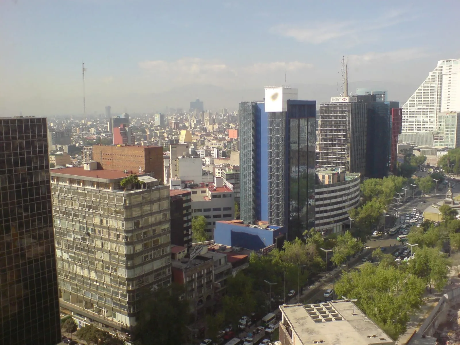 The Paseo de la Reforma skyline of Mexico City under a hazy sky