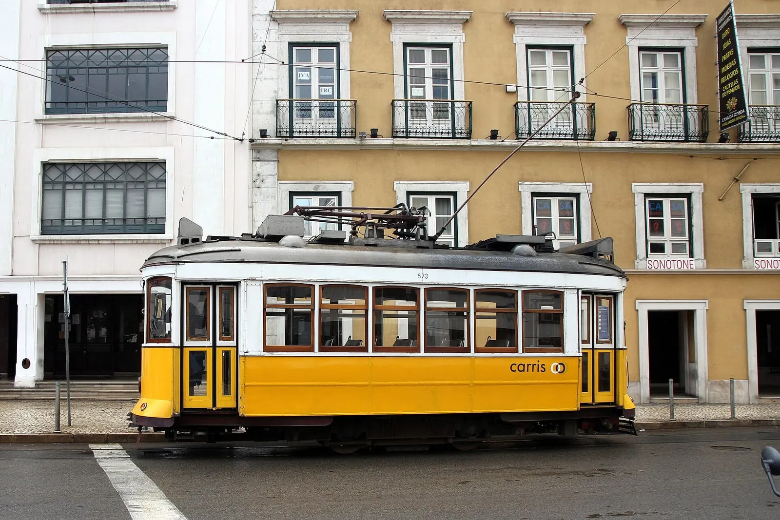 A yellow tram on a street in Lisbon, Portugal